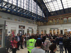 Protesters mingled with commuters while Southern Rail employee looked on