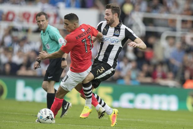 Antony Knockaert (left) is challenged by Newcastle defender Paul Dummett.