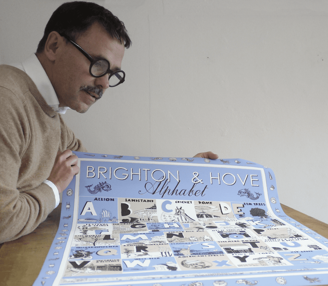 Alej ez with his 'Brighton and Hove Illustrated Alphabet' that shows in alphabetical order places, events and people that we love in Brighton and Hove.