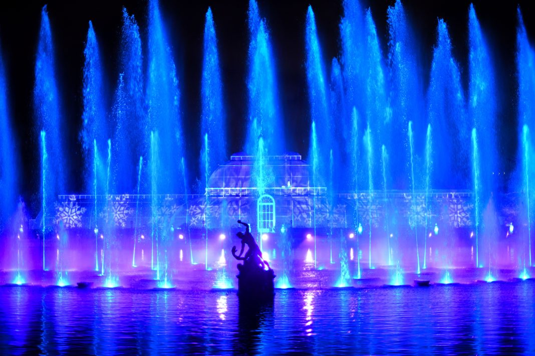 Christmas at Kew light trail installation" / "Christmas at Kew Palm House Pond fountain display"